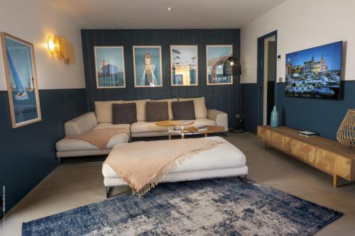 un salon avec un canapé et une table dans l'établissement La villa Terracotta - Villa de rêve au calme à 900 m de l'océan avec piscine chauffée, à Sainte-Marie de Ré