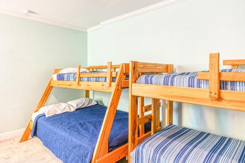 two bunk beds in a room with blue sheets at SML Ski School in Moneta