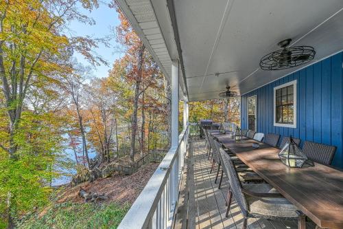 a porch with wooden tables and chairs and trees at SML Ski School in Moneta