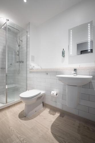a bathroom with a toilet and a sink and a shower at Miller & Carter Heaton Chapel by Innkeeper's Collection in Manchester