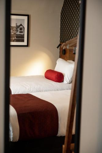 a mirror reflection of two beds in a hotel room at Miller & Carter Heaton Chapel by Innkeeper's Collection in Manchester