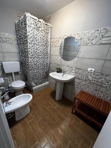 a bathroom with two toilets and a sink at Fiera di Roma B&B in Ponte Galeria