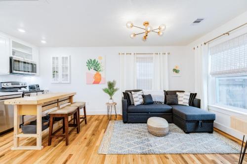 a living room with a couch and a table at Barefoot Coastal Cottage in Galveston