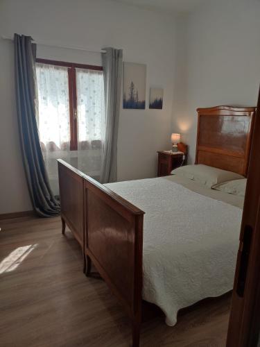 a bedroom with a large bed and a window at Agriturismo Nonnamelia in Nasino