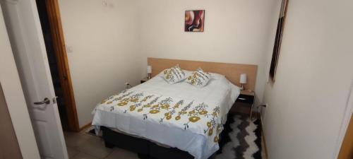 a bedroom with a bed with gold decorations on it at APART HOTEL EN BULNES in Bulnes