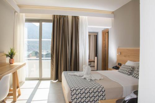 a hotel room with a bed and a large window at Bali Diamond "by Checkin" Adults Only in Bali