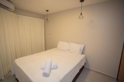 A bed or beds in a room at Condomínio Villa Belém em Intermares por Carpediem