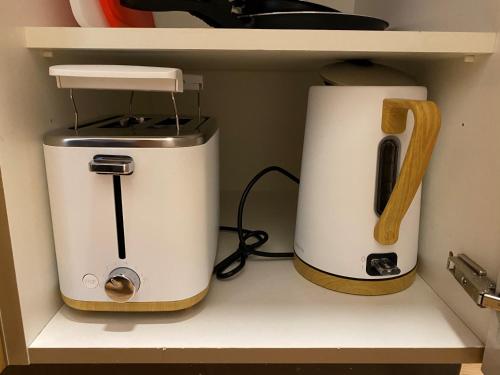 two toasters sitting on a shelf in a kitchen at Sonnenhof in Kals am Großglockner