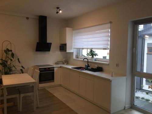 a kitchen with a window and a sink and a stove at Apartament IGA in Biała Podlaska
