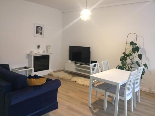 a living room with a couch and a table and a tv at Apartament IGA in Biała Podlaska