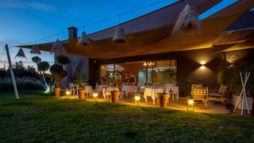 a patio with a table and lights on the grass at Villa Jardins D'Isa in Marrakech