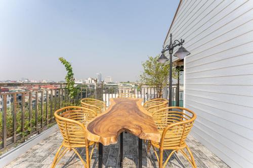 a wooden table and chairs on a balcony at Veshia Hotel & Spa in Hanoi