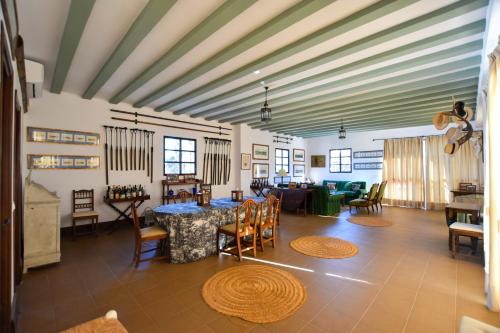 a living room with a table and chairs at Finca Santa Maria de las Cañadas in El Garrobo