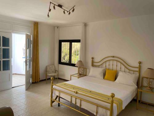 a bedroom with a large bed with yellow pillows at TérangaLux Collection Villa Green House Mamelles in Dakar