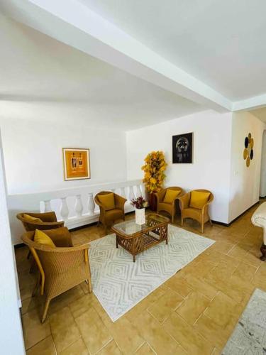 a living room with a couch and chairs and a table at TérangaLux Collection Villa Green House Mamelles in Dakar