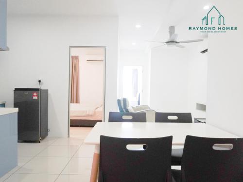 a dining room with a table and chairs and a bedroom at Gurney Drive Mansion One Serviced Apartment in George Town