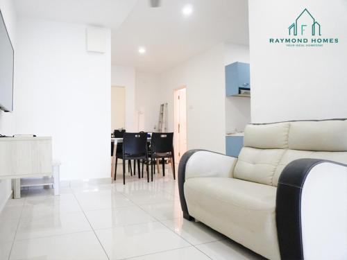 a living room with a white couch and a table at Gurney Drive Mansion One Serviced Apartment in George Town