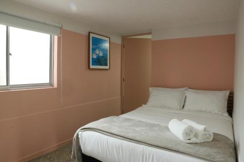 a bedroom with a bed with a towel on it at Hotel Bania travels in Guatapé