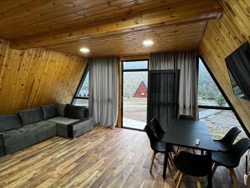 a living room with a couch and a piano at Green Villa Resort Grey in Dilijan