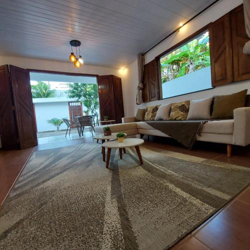 a living room with a couch and a table at Residência Thomas in Itacaré