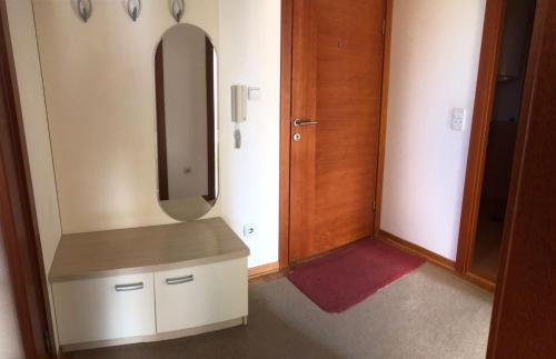a bathroom with a sink and a mirror at Apartmani IVANA in Vrnjačka Banja