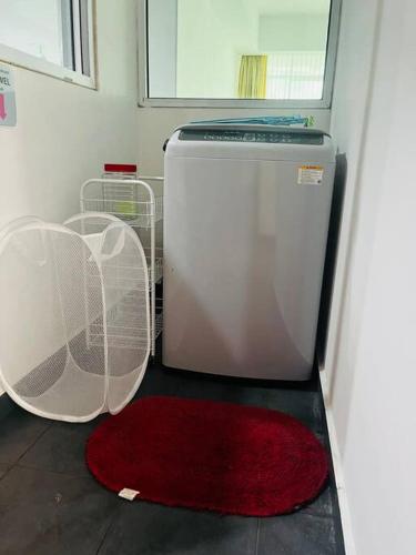 a red rug sitting on the floor next to a refrigerator at Bay Resort Condominium 3-bedrooms with Swimming Pool near the Seaside in Miri