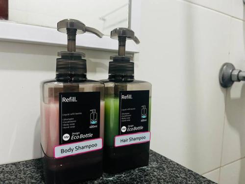 two bottles of soap sitting on top of a counter at Bay Resort Condominium 3-bedrooms with Swimming Pool near the Seaside in Miri