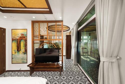 a hotel room with a bed and a window at Veshia Hotel & Spa in Hanoi
