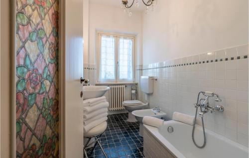a bathroom with two toilets and a tub and a sink at Nice Apartment In Verucchio With Kitchen in Verucchio