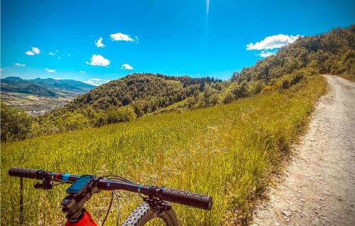 a bike parked on the side of a dirt road at 2 Bedroom Cozy Apartment In Verucchio in Verucchio