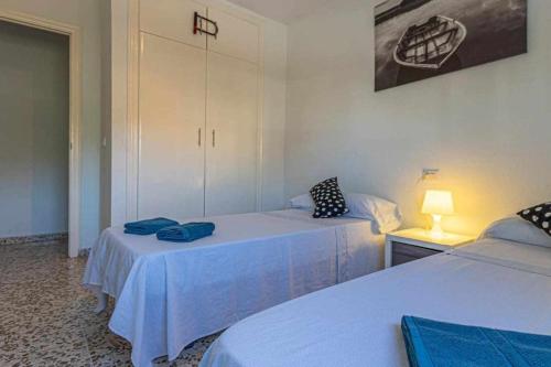 a room with two beds with blue towels on them at 797 Holiday Rentals - Espacioso apartamento para 6 en torremolinos in Torremolinos
