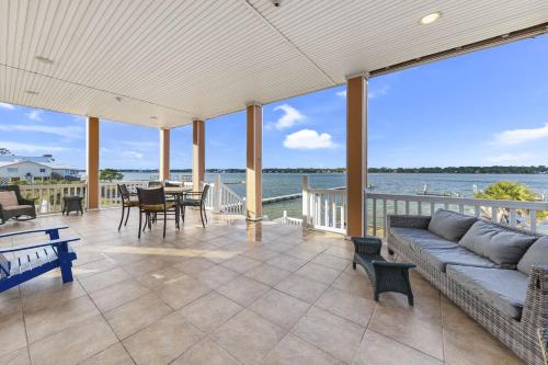 a large living room with a couch and a view of the water at Krusty Crab in Gulf Shores