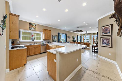 a large kitchen with wooden cabinets and a large island at Krusty Crab in Gulf Shores