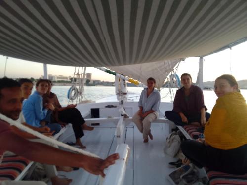 a group of people sitting on a boat at Nile View Guest House in Aswan