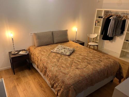 a bedroom with a large bed with two night stands and two lamps at City apartment mini-spa in Tallinn