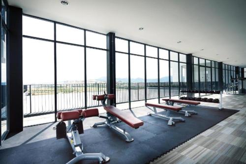 a large room with a large glass window with benches at Simplicity Cozy For 2 -Trefoil Setia Alam- Near Setia City Mall-Setia Convention Centre in Shah Alam