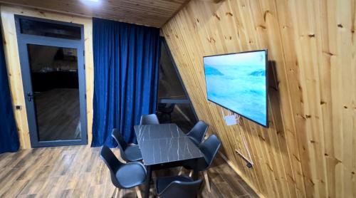 a conference room with a table and chairs and a screen at Green Villa Resort Blue in Dilijan