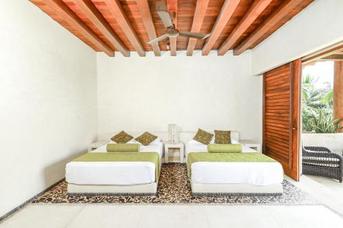 a living room with two beds and a table at Beautiful Family House Beachfront in La Unión