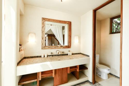 a bathroom with a sink and a mirror at Beautiful Family House Beachfront in La Unión