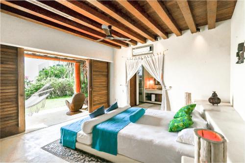 a bedroom with a large bed and a large window at Beautiful Family House Beachfront 