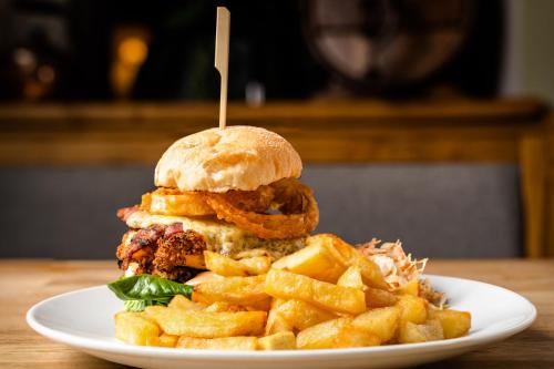 a sandwich and french fries on a white plate at Bower House Inn in Eskdale