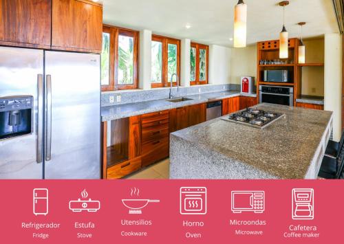 a kitchen with wooden cabinets and stainless steel appliances at Beautiful Family House Beachfront in La Unión