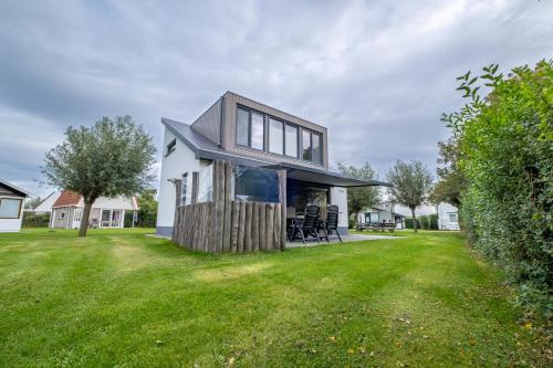 a house with a large yard with grass at Vakantiehuis aan de duinen van Vlissingen VL22 in Vlissingen