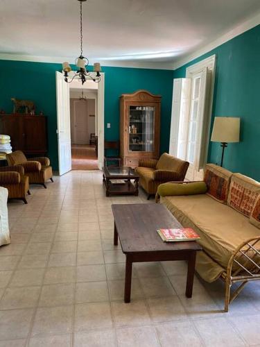 a living room with a couch and a table at Casa de campo “Los Ombues” in Suipacha