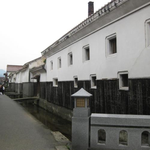 a row of buildings next to a canal at Kyukamura Oku-Daisen in Daisen