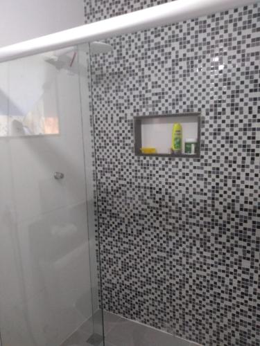 uma casa de banho com um chuveiro e uma porta de vidro em Casa familiar em Angra dos Reis