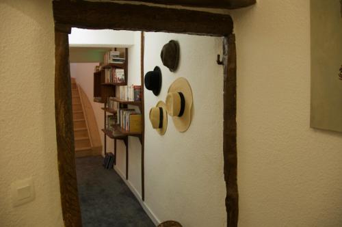 a door in a room with hats on the wall at Maison Georges Couthon in Orcet
