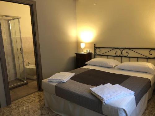 a bedroom with a bed and a bathroom with a shower at Relais B&B Corte Dei Turchi in Longiano