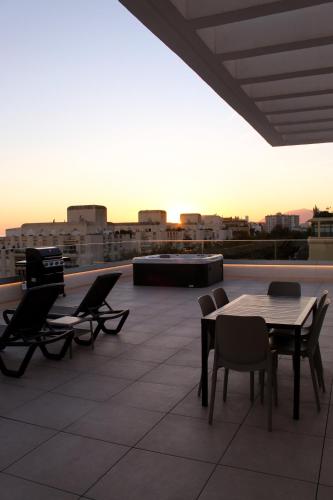 a patio with a table and chairs on a roof at Aqua Apartments Bellamar, Marbella in Marbella