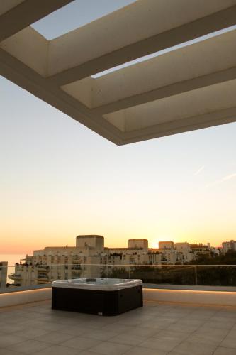 a table in a room with a view of a city at Aqua Apartments Bellamar, Marbella in Marbella